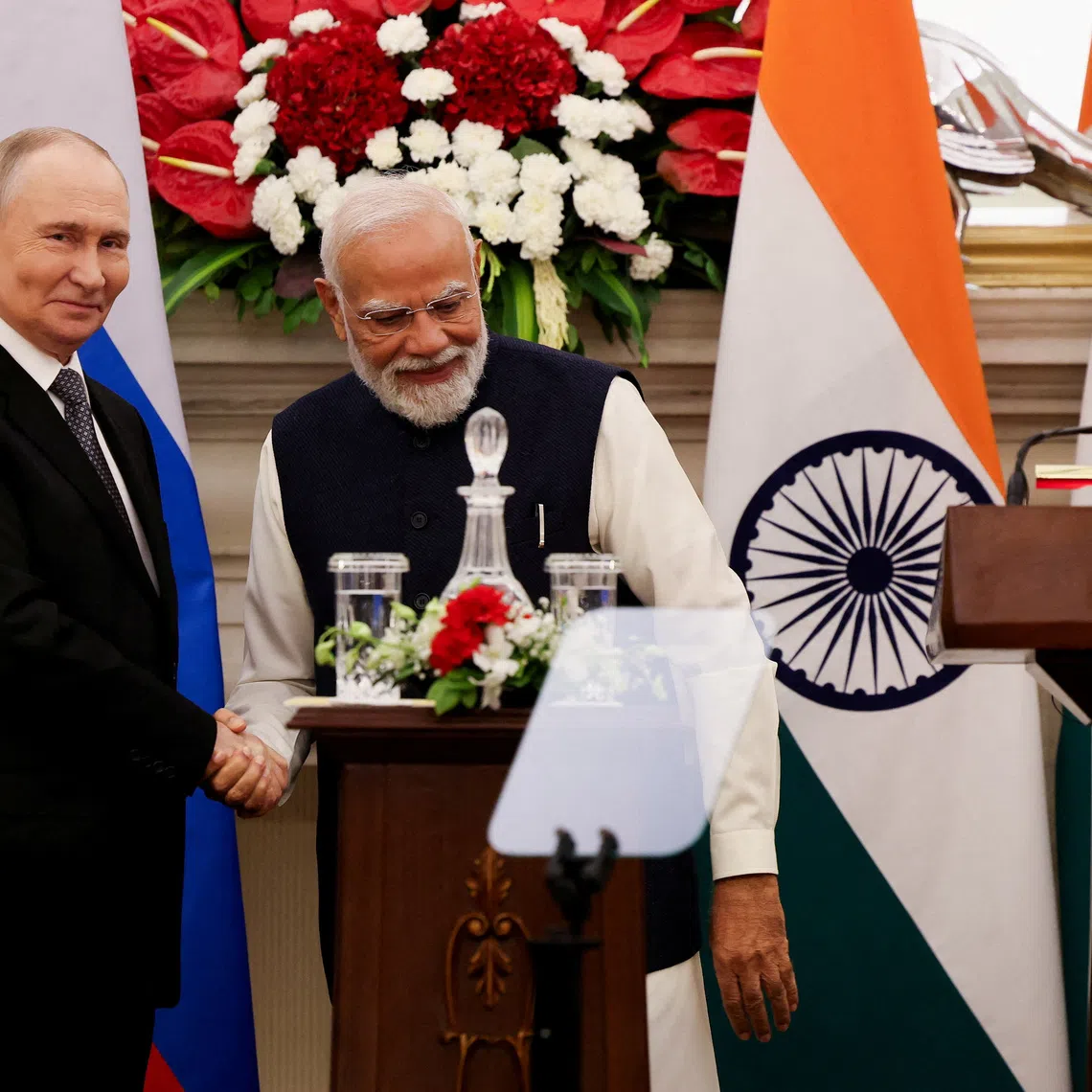 FILE PHOTO: Russian President Vladimir Putin and India's Prime Minister Narendra Modi shake hands as they attend a presentation of a joint statement after their delegation level talks at Hyderabad House in New Delhi, India, December 5, 2025. REUTERS/Adnan Abidi/File Photo