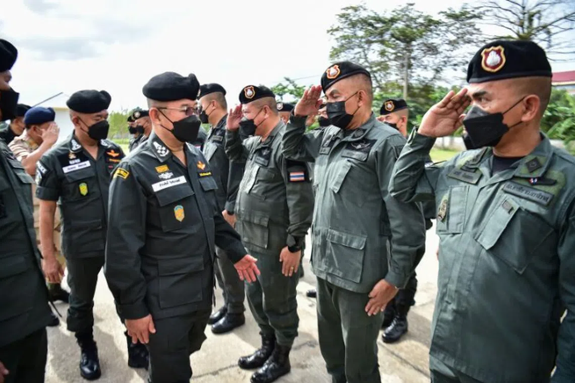 Thailand's national police chief Damrongsak Kittipraphat (left) inspects security forces in the restive southern province of Narathiwat in January 2023. 