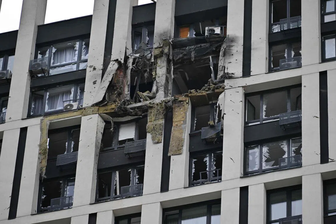 TOPSHOT - This photograph taken on July 13, 2023, shows a high-rise residential building damaged by remains of a shot down Russian drone in Kyiv, amid the Russian invasion of Ukraine. Ukraine said on July 13, 2023, it had downed 20 Russian attack drones and two cruise missiles in a third night of strikes on Kyiv and elsewhere in the country. (Photo by Genya SAVILOV / AFP)