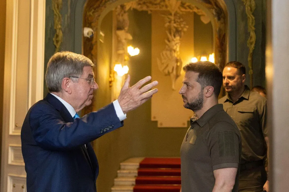 A July 2022 photo shows IOC chief Thomas Bach (left) in Kyiv with Ukrainian President Volodymyr Zelensky.