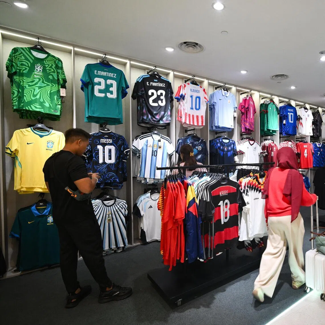 Customers browsing Weston Corporation’s World Cup Pop-up Jewel store at Jewel Changi Airport on July 1.