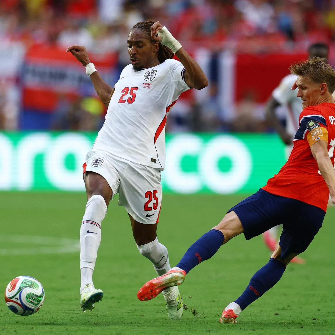 Soccer Football - FIFA World Cup 2026 - Quarter Final - Norway v England - Miami Stadium, Miami Gardens, Florida, U.S. - July 11, 2026 England's Djed Spence in action with Norway's Martin Odegaard IMAGN IMAGES via Reuters/Nathan Ray Seebeck