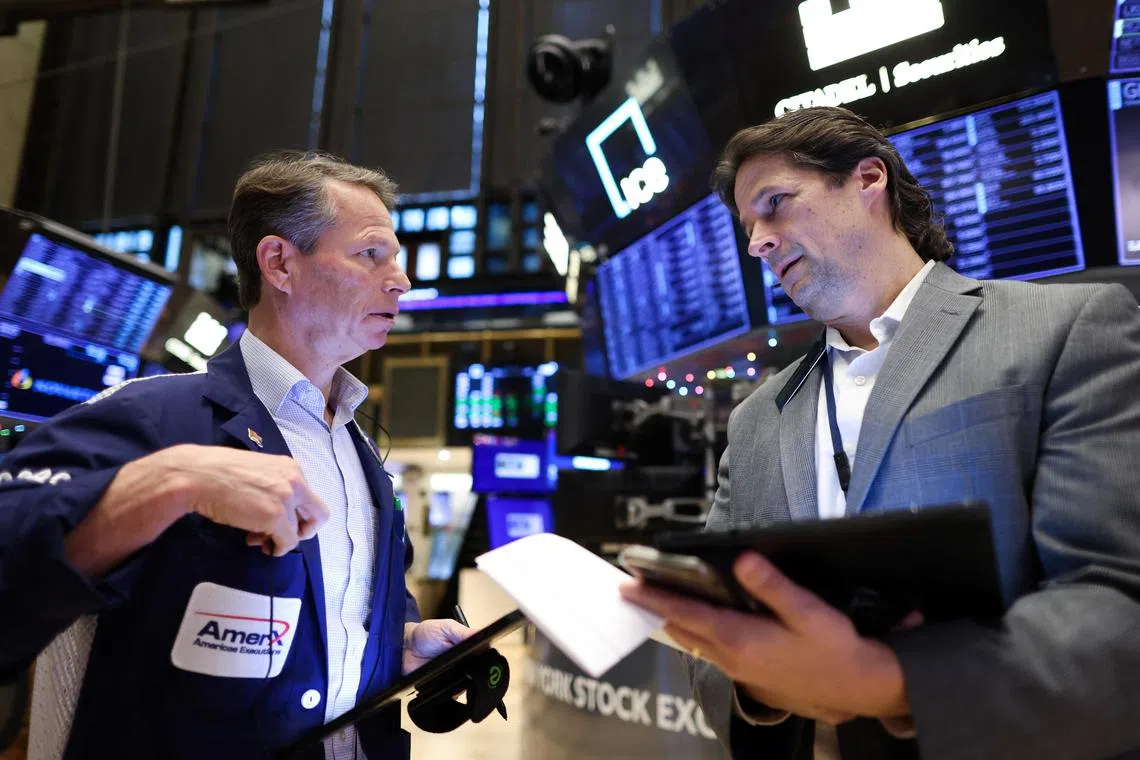Traders work on the floor at the New York Stock Exchange.