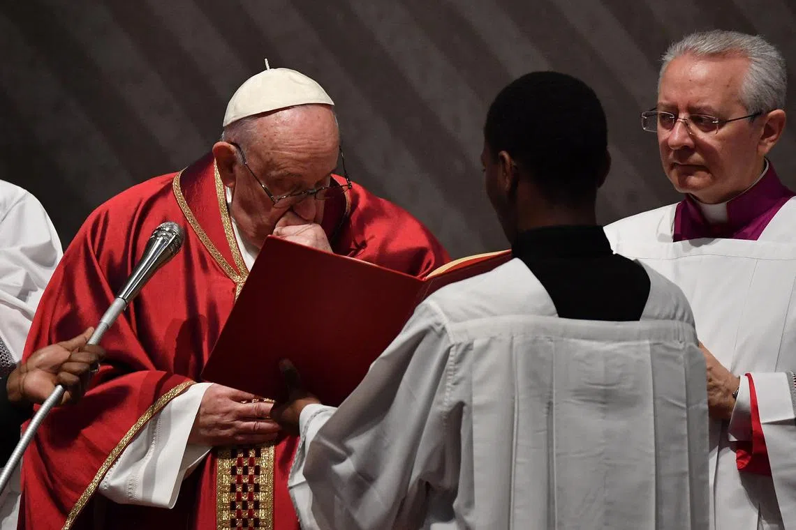 Pope Francis coughs as he presides over the Passion of the Lord mass on Good Friday.