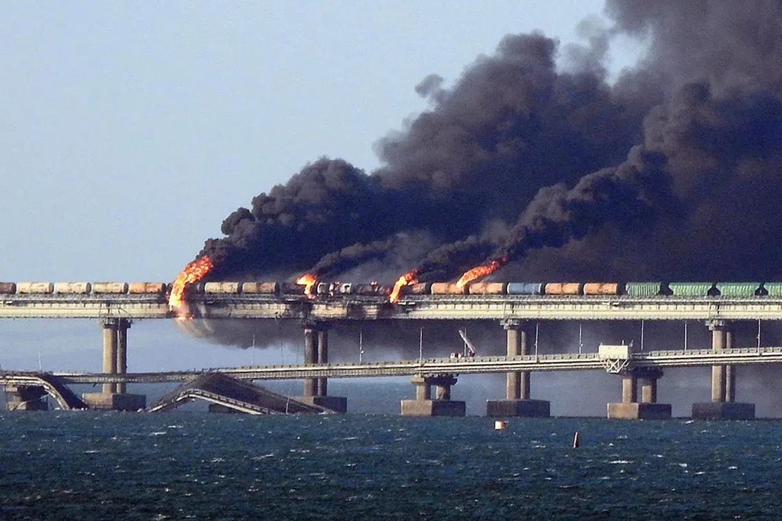 -- AFP PICTURES OF THE YEAR 2022 --

Black smoke billows from a fire on the Kerch bridge that links Crimea to Russia, after a truck exploded, near Kerch, on October 8, 2022. - Moscow announced on October 8, 2022 that a truck exploded igniting a huge fire and damaging the key Kerch bridge -- built as Russia's sole land link with annexed Crimea -- and vowed to find the perpetrators, without immediately blaming Ukraine. (Photo by AFP) / AFP PICTURES OF THE YEAR 2022