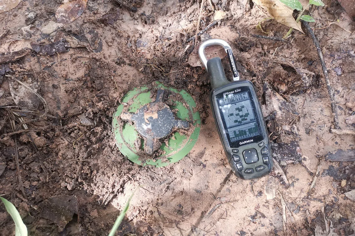 A GPS device is placed near a PMN-2 mine that Thailand says it found near a forested disputed border between Thailand and Cambodia in the Chong Bok area, following the first incident on July 16 that severed a Thai soldier’s left ankle while he was on patrol, in Ubon Ratchathani province, Thailand, July 18, 2025. The Royal Thai Army/Handout via REUTERS