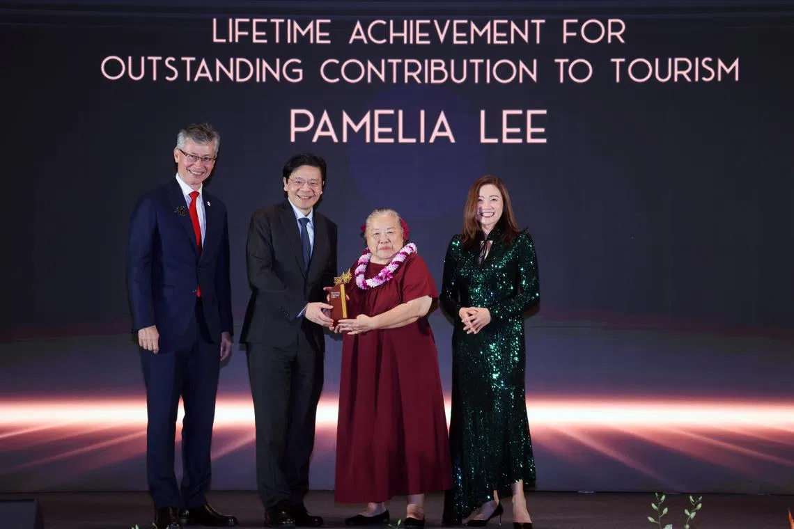 Tourism-sector pioneer Pamelia Lee (third from left) receiving an award award with (from left) STB chairman Olivier  Lim, PM Lawrence Wong and chief executive Melissa Ow.