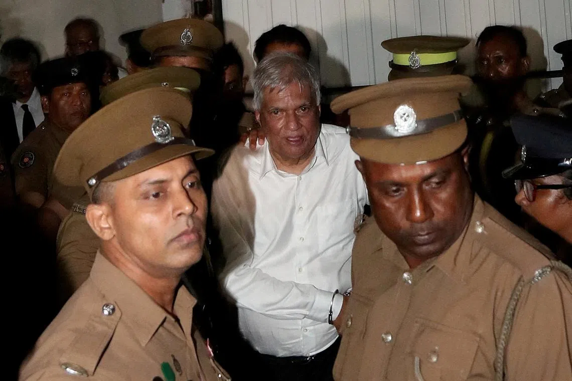 FILE PHOTO: Sri Lanka's former President Ranil Wickremesinghe is escorted by prison and police officials as he leaves the Magistrate’s Court in Colombo, Sri Lanka, August 22, 2025. REUTERS/Lahiru Harshana/File Photo