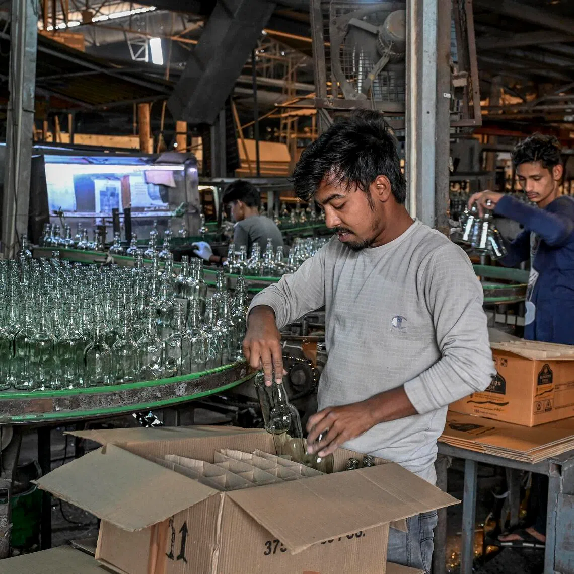 Workers at a glass factory in Firozabad, India, on April 21.