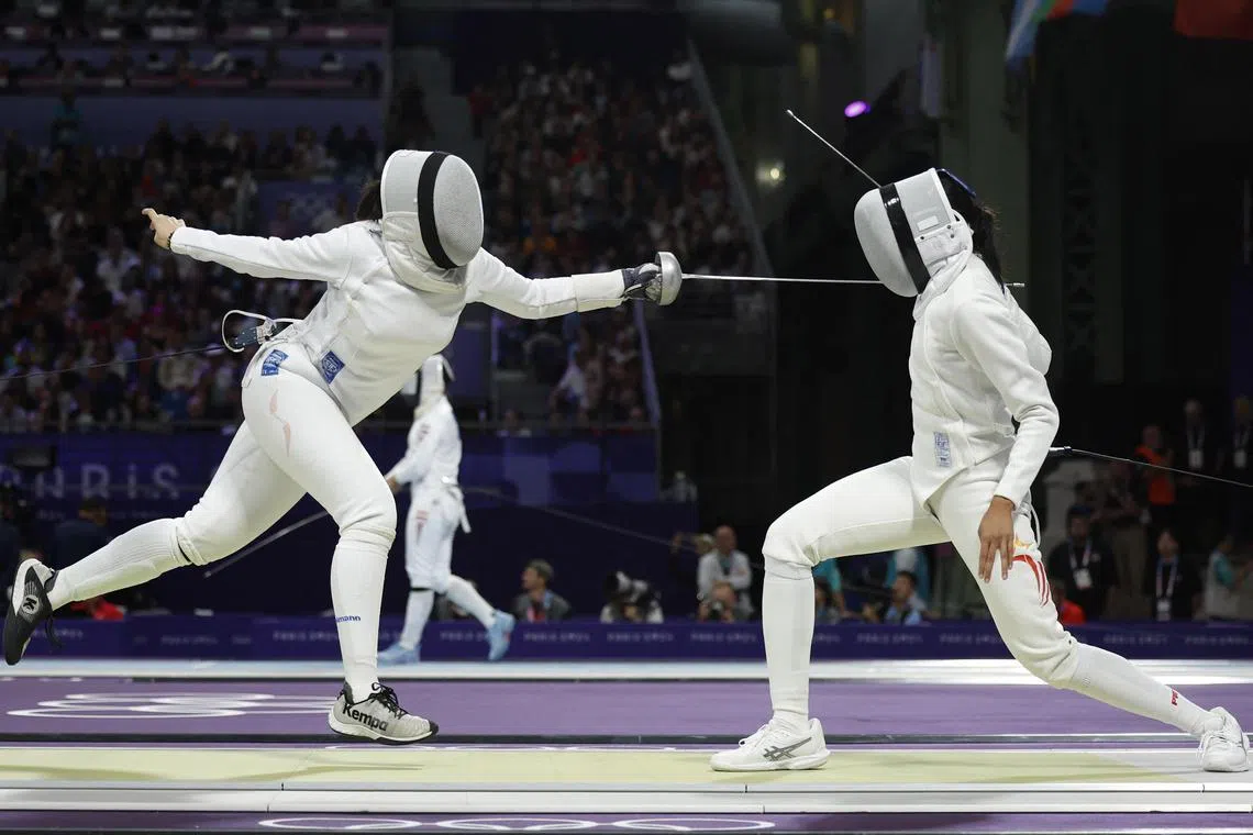 Kiria Tikanah Abdul Rahman of Singapore (right) in action against Maria Luisa Doig Calderon of Peru in the women's epee table of 64.