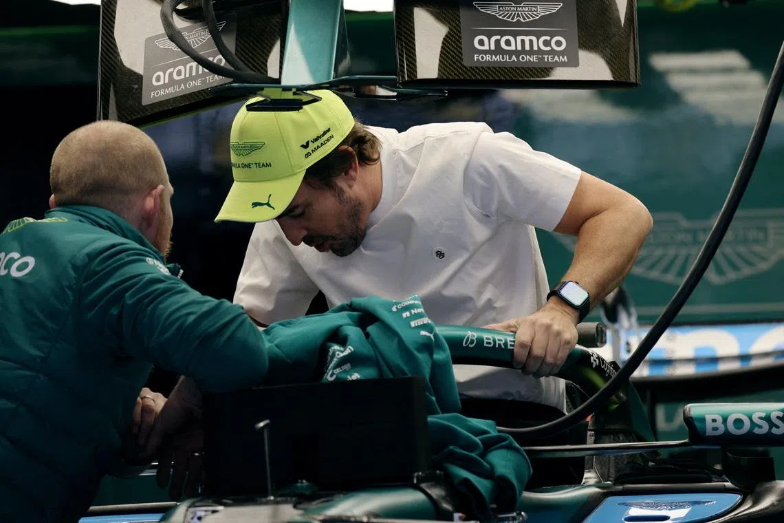 Formula One F1 - Chinese Grand Prix - Shanghai International Circuit, Shanghai, China - March 12, 2026 Aston Martin's Fernando Alonso with an engineer in the garage ahead of the Chinese Grand Prix. REUTERS/Go Nakamura