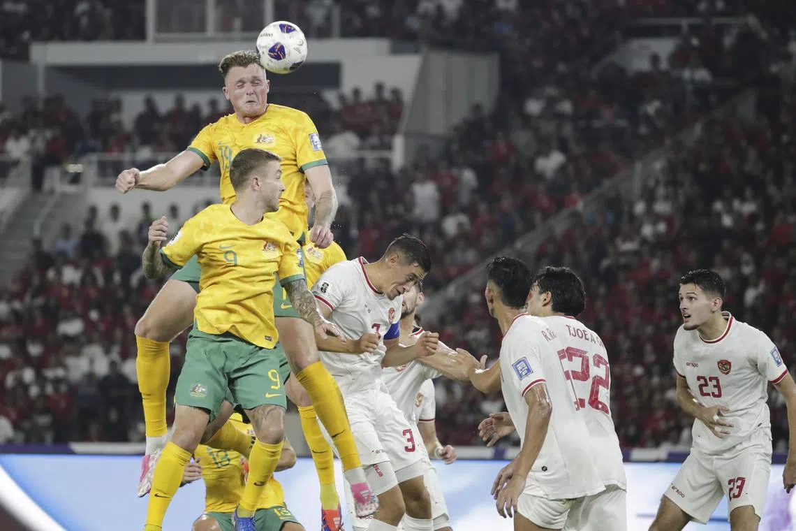 Harry Souttar (left) of Australia in action against Jay Noah Idzes (third from left) of Indonesia.