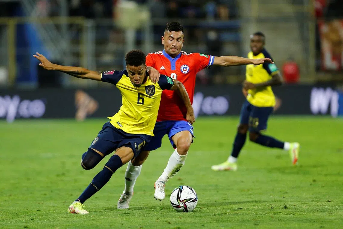 Ecuador's Byron Castillo trying to evade the attentions of Chile's Jean Meneses during the World Cup qualifiers in late 2021. Chile and Peru  unsuccessfully challenged his eligibility for Ecuador.