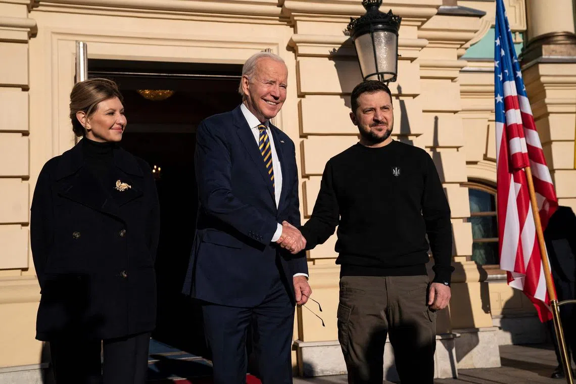 US President Joe Biden (C) poses for a photograph with Ukrainian President Volodymyr Zelensky (R) and his wife Olena Zelenska (L), upon his arrival at the Mariinsky Palace in Kyiv on Feb 20, 2023.