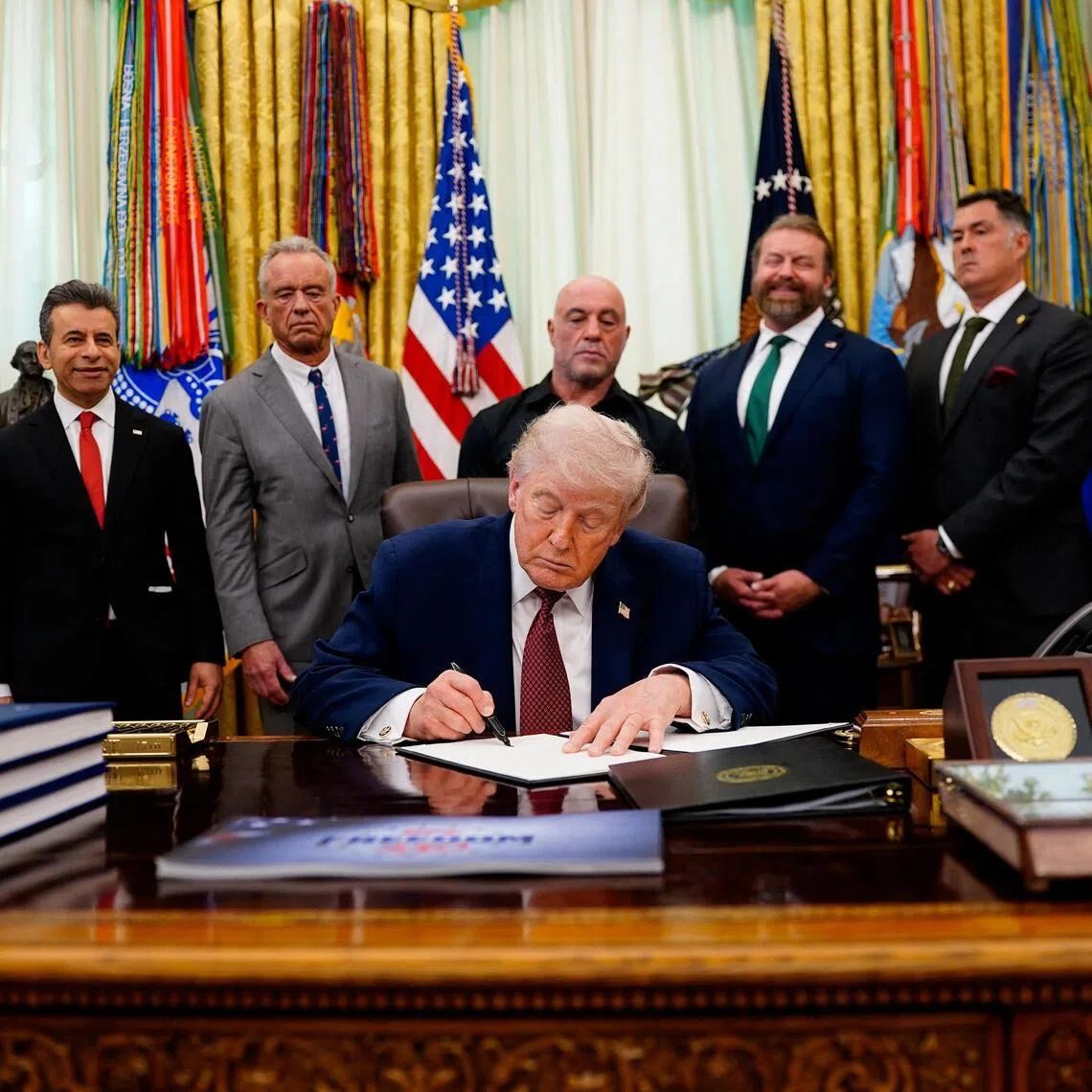US President Donald Trump signs an executive order about easing restrictions on mental health treatments, including, ibogaine, in the Oval Office of the White House in Washington on April 18, 2026. 