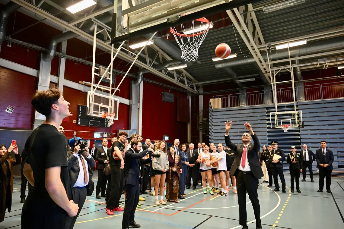 President Tharman Shanmugaratnam trying out some basketball shooting at the Fryshuset on Oct 20.