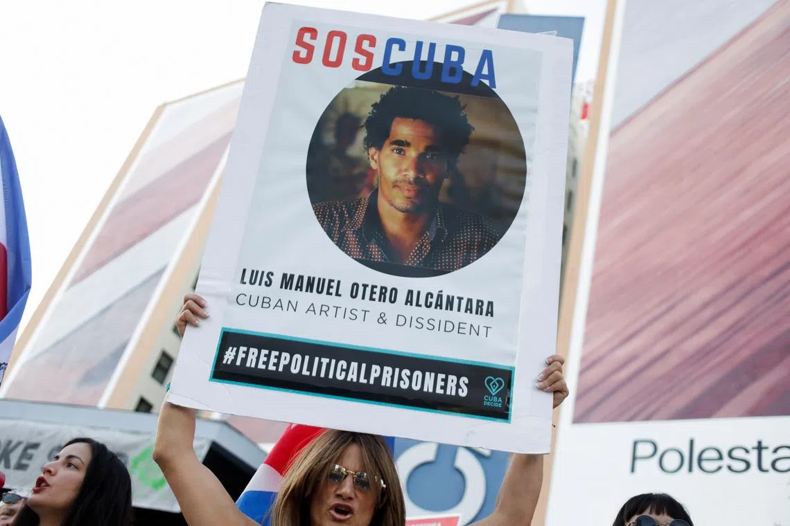FILE PHOTO: A person holds a sign in support of Cuban artist Luis Manuel Otero Alcantara on a street as the ninth Summit of the Americas takes place, in Los Angeles, California, U.S. June 7, 2022. REUTERS/Daniel Becerril/File Photo