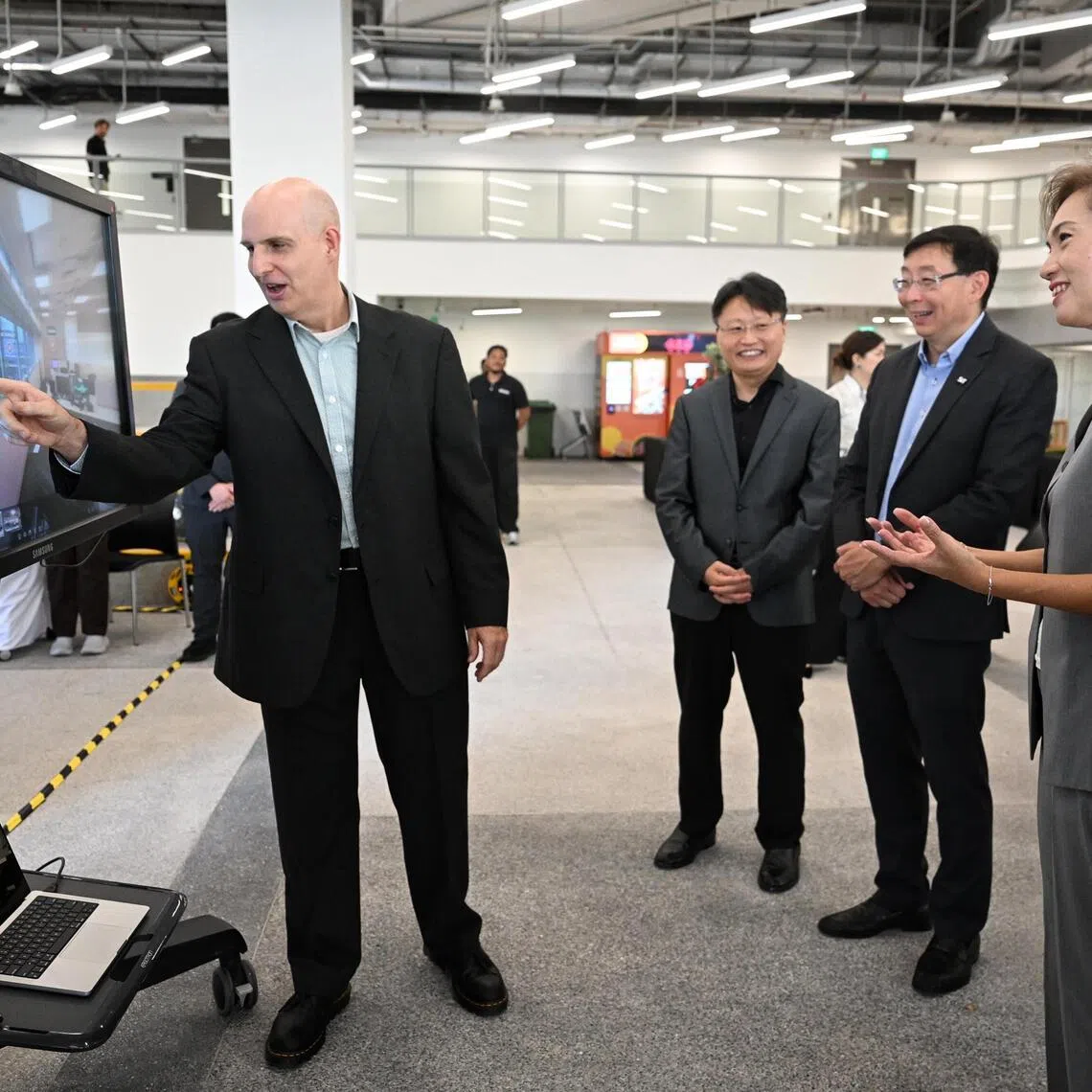 Minister for Digital Development and Information Josephine Teo being taken on a virtual tour of the SIT x Nvidia AI Centre by Professor Ian McLoughlin from the Singapore Institute of Technology at the official opening of the centre on Oct 2. 