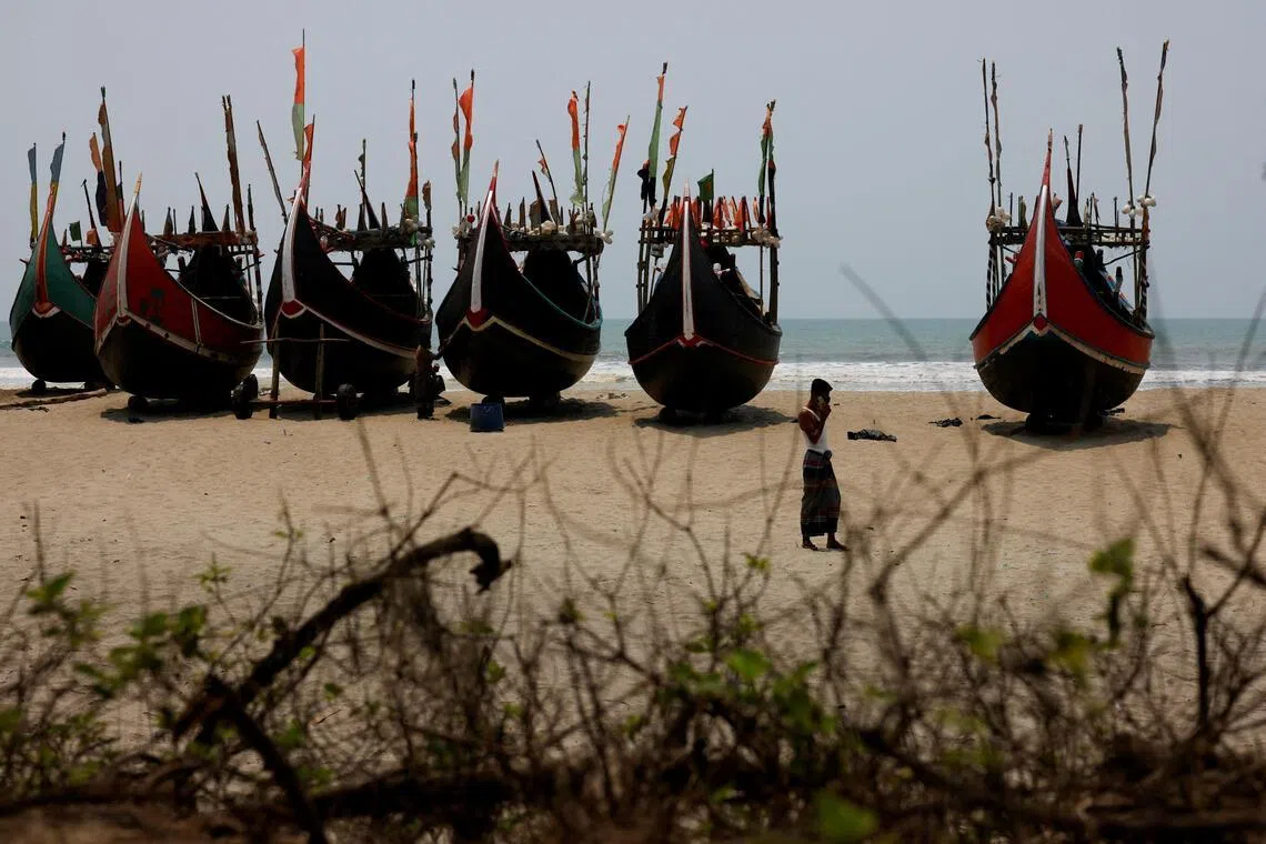 Faisal, 24, a human trafficker, speaks on a mobile phone at a beach near a Rohingya refugee camp, after a boat carrying Rohingya refugees and Bangladeshi nationals capsized in the Andaman Sea, Cox’s Bazar, Bangladesh, April 17, 2026. REUTERS/Mohammad Ponir Hossain     TPX IMAGES OF THE DAY