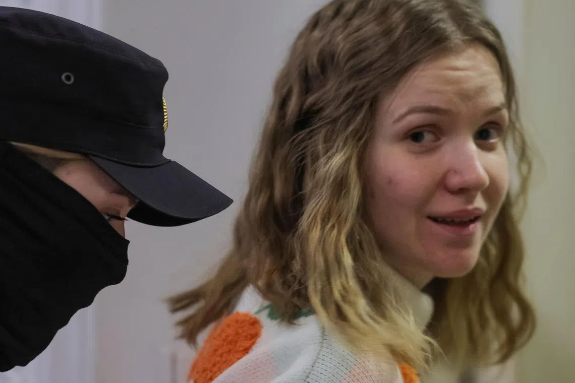 A law enforcement officer escorts Darya Trepova after her court hearing in Saint Petersburg, Russia.