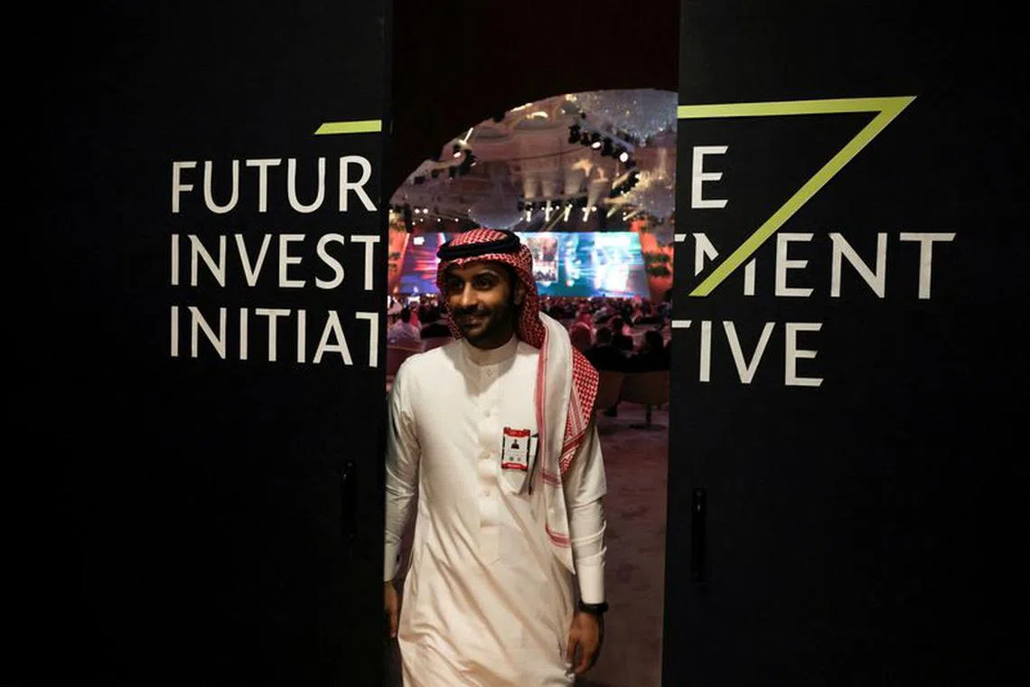 FILE PHOTO: A Saudi man's reflection is seen in mirror glass at the Future Investment Initiative conference, in Riyadh, Saudi Arabia, October 25, 2022. REUTERS/ Ahmed Yosri/File Photo