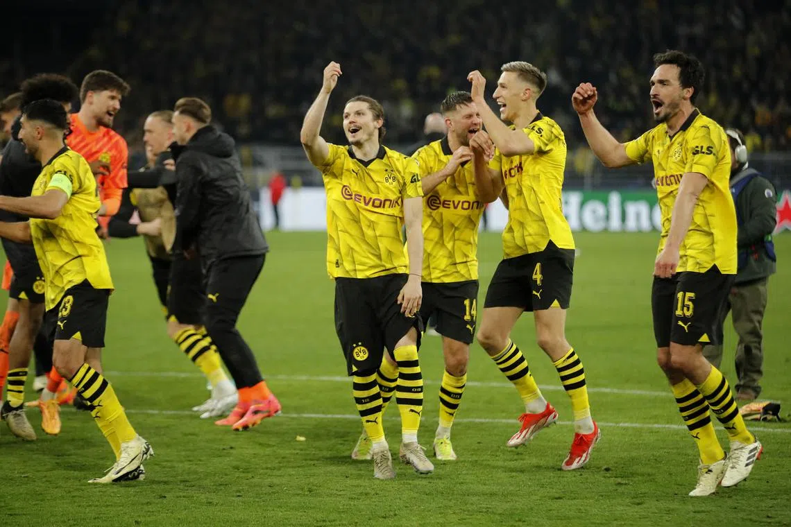 Borussia Dortmund players celebrating after beating Atletico Madrid in the Champions League quarter-finals.