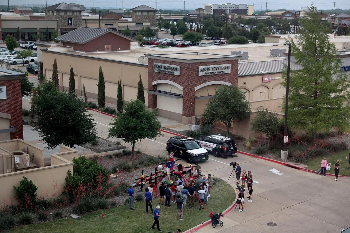 ALLEN, TEXAS - MAY 07: People gather around a memorial at one of the entrances to the Allen Premium Outlets mall on May 7, 2023 in Allen, Texas. According to reports, a shooter opened fire at the outlet mall, killing eight people. The gunman was then killed by an Allen Police officer that was responding to an unrelated call.   Joe Raedle/Getty Images/AFP (Photo by JOE RAEDLE / GETTY IMAGES NORTH AMERICA / Getty Images via AFP)