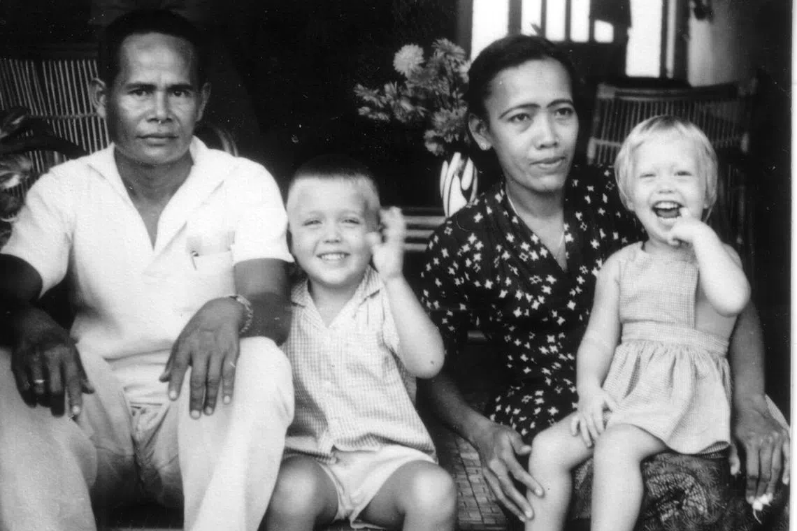 Siblings Paul and Ingrid Schroder at the back of their family's flat in Dunearn Road in 1960, with their amah Rukiah and her husband Rohani.