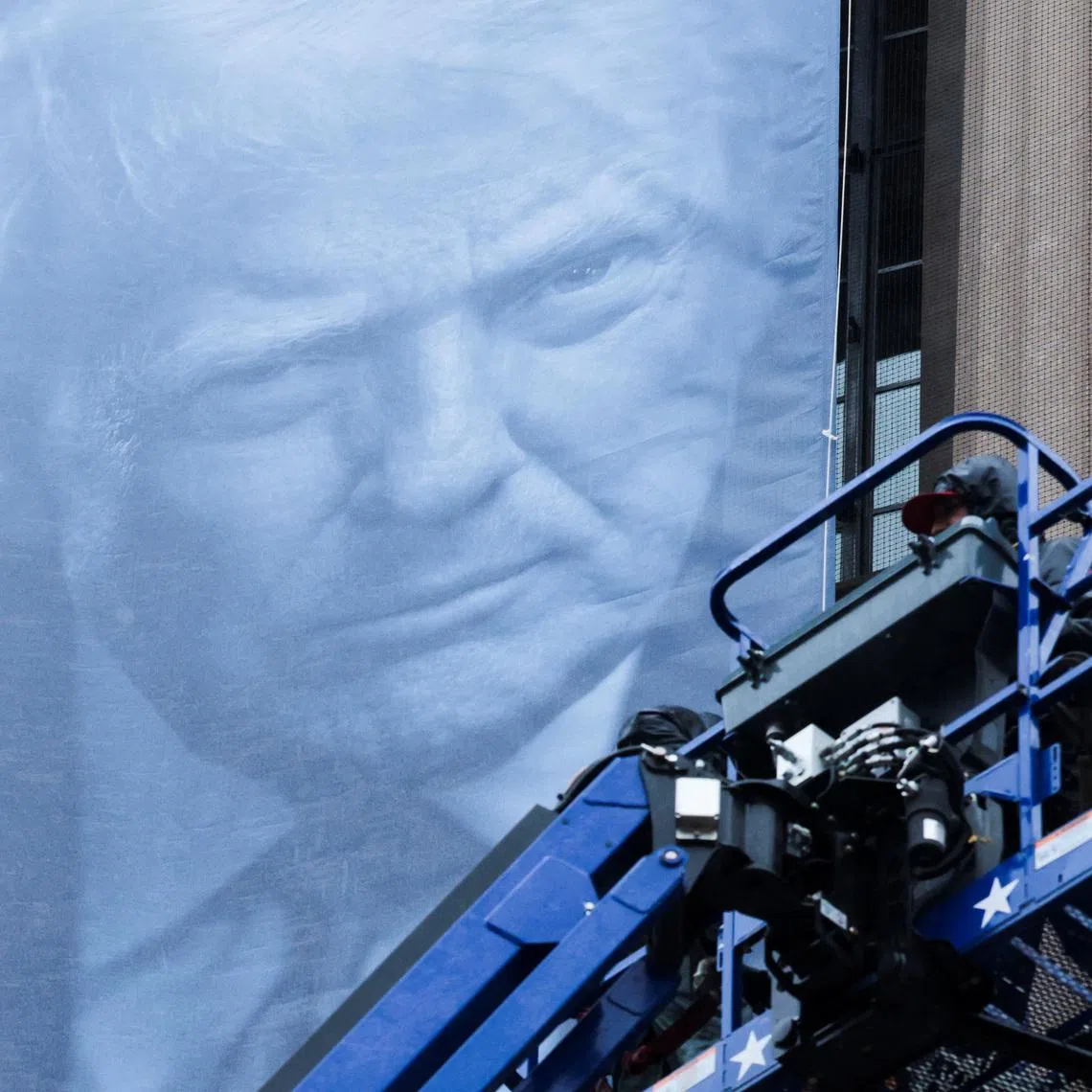 A new banner depicting U.S. President Donald Trump is hung on the Department of Justice building in Washington, D.C., U.S., February 19, 2026. REUTERS/Jonathan Ernst