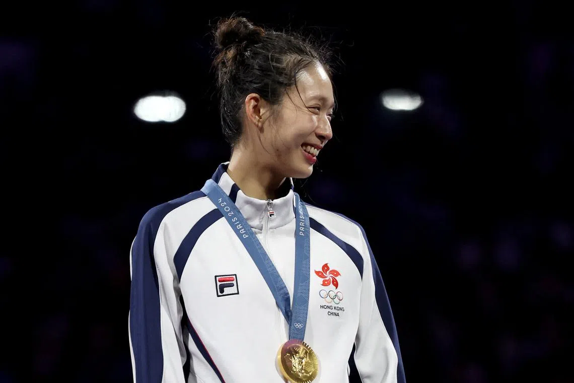 FILE PHOTO: Paris 2024 Olympics - Fencing - Women's Epee Individual Victory Ceremony - Grand Palais, Paris, France - July 27, 2024. Gold medalist Man Wai Vivian Kong of Hong Kong celebrates with her medal in the Women's Epee Fencing. REUTERS/Maye-E Wong/File Photo