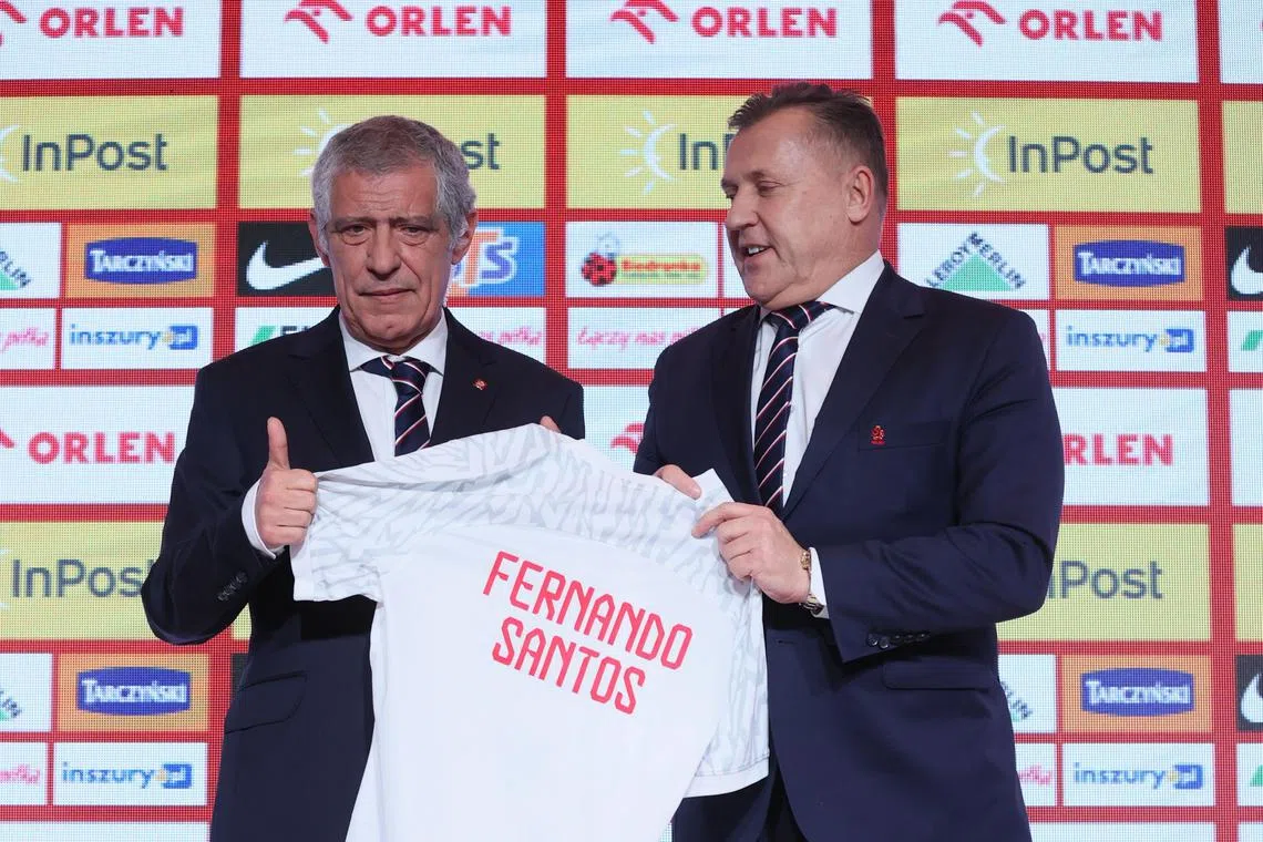 Portuguese Fernando Santos (left), new head coach of the Polish national football  team, and Polish federation president Cezary Kulesza pose during the manager's  presentation at a press conference in Warsaw on Tuesday. 