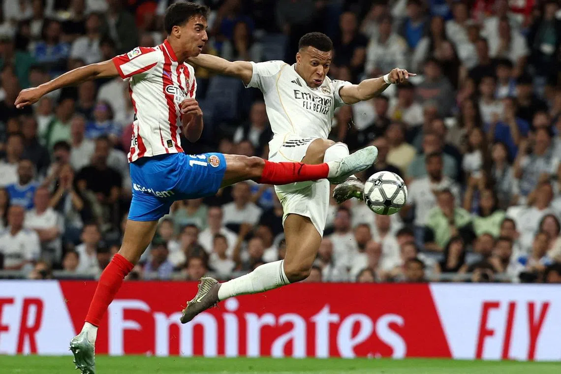 Soccer Football - LaLiga - Real Madrid v Girona - Santiago Bernabeu, Madrid, Spain - April 10, 2026 Girona's Vitor Reis in action with Real Madrid's Kylian Mbappe REUTERS/Gonzalo Fuentes
