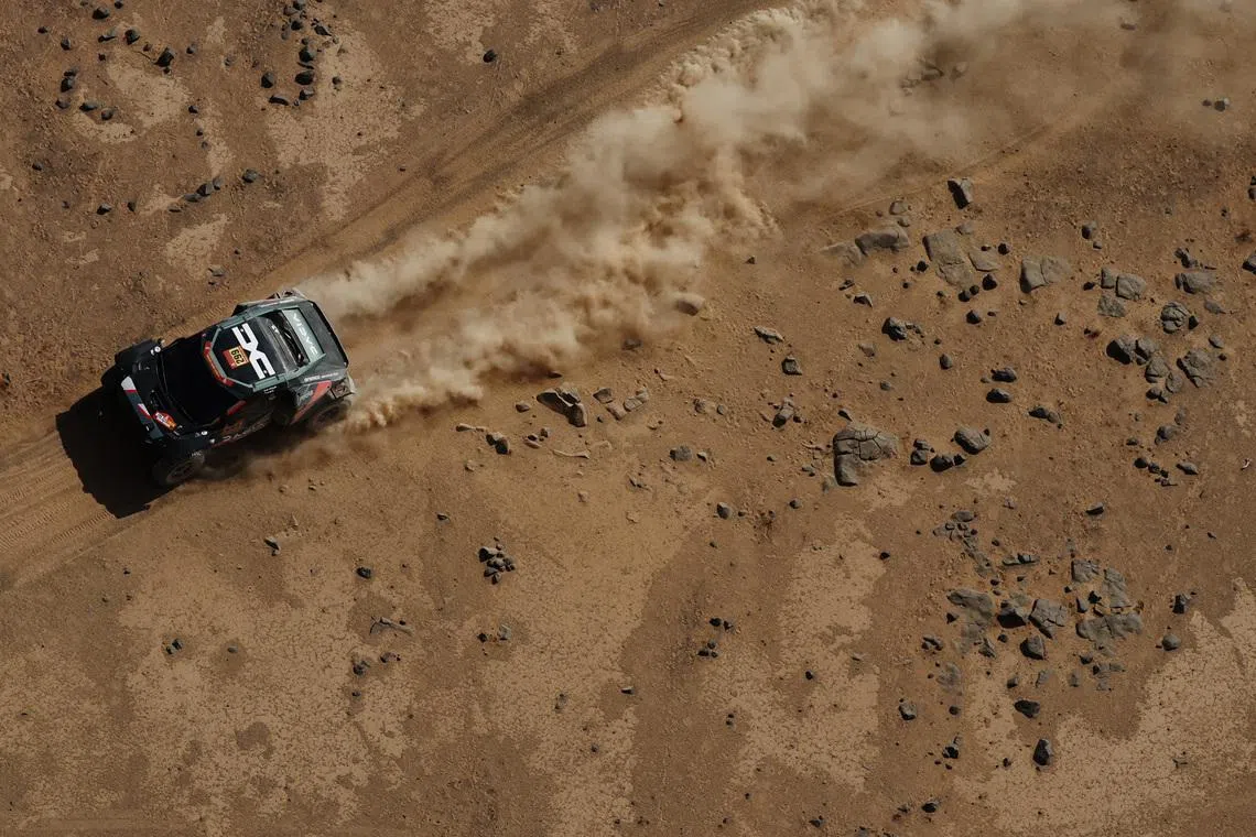Rallying - Dakar Rally - Stage 11 - Bisha to Al Henakiyah - Bisha, Saudi Arabia - January 15, 2026 Dacia's Nasser Al-Attiyah and Fabian Lurquin in action during stage 11. REUTERS/Stephane Mahe