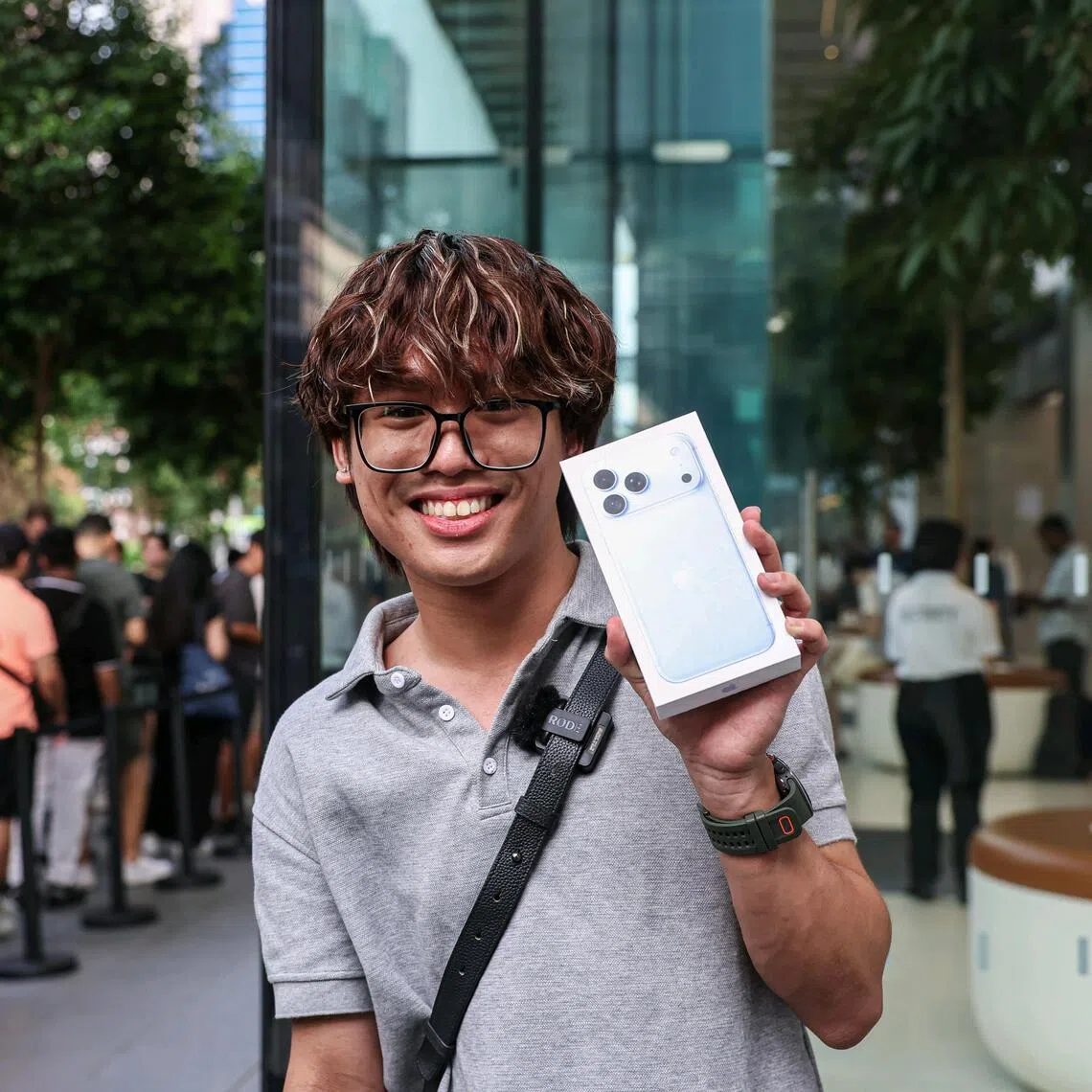 Hector Yong, an ITE College East student and the first customer in the queue, with his iPhone 18 Pro Max on Sept 18. He started queuing at 11pm the previous night.