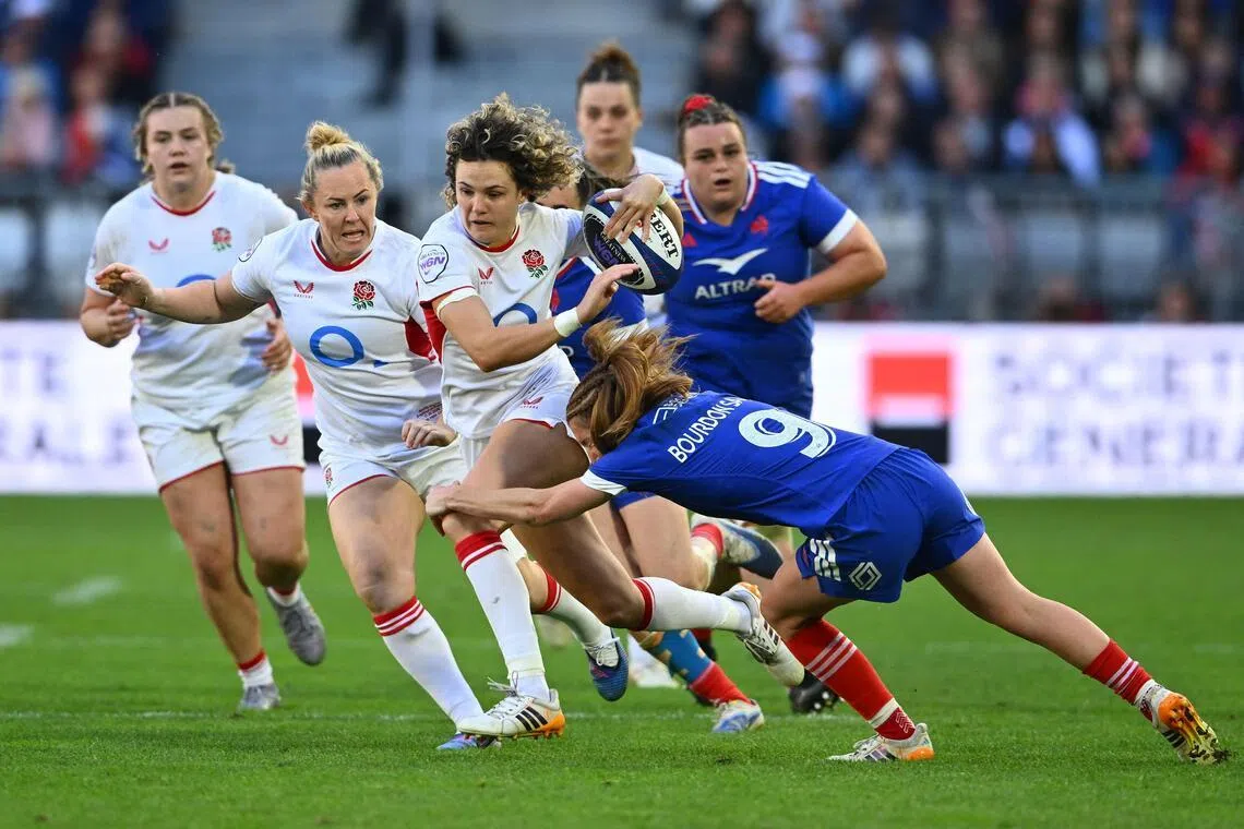 England's fullback Ellie Kildunne is tackled by France's scrum-half Pauline Bourdon Sansus as she runs with the ball during the Women's Six Nations international rugby union match at the Stade Atlantique in Bordeaux on May 17, 2026.