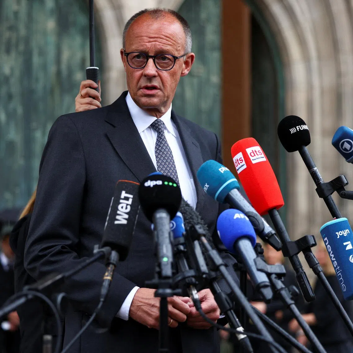 German Chancellor Friedrich Merz also questioned how the suspect was able to approach the event despite supposedly being under constant surveillance.