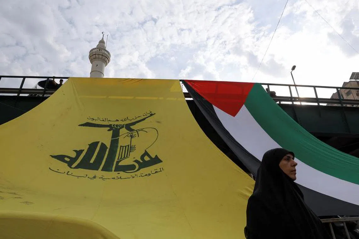 FILE PHOTO: A woman looks on, as Hezbollah supporters protest in solidarity with Palestinians in Gaza, amid the ongoing conflict between Israel and Palestinian Islamist group Hamas, in Beirut, Lebanon, October 27, 2023. REUTERS/Amr Alfiky/File photo