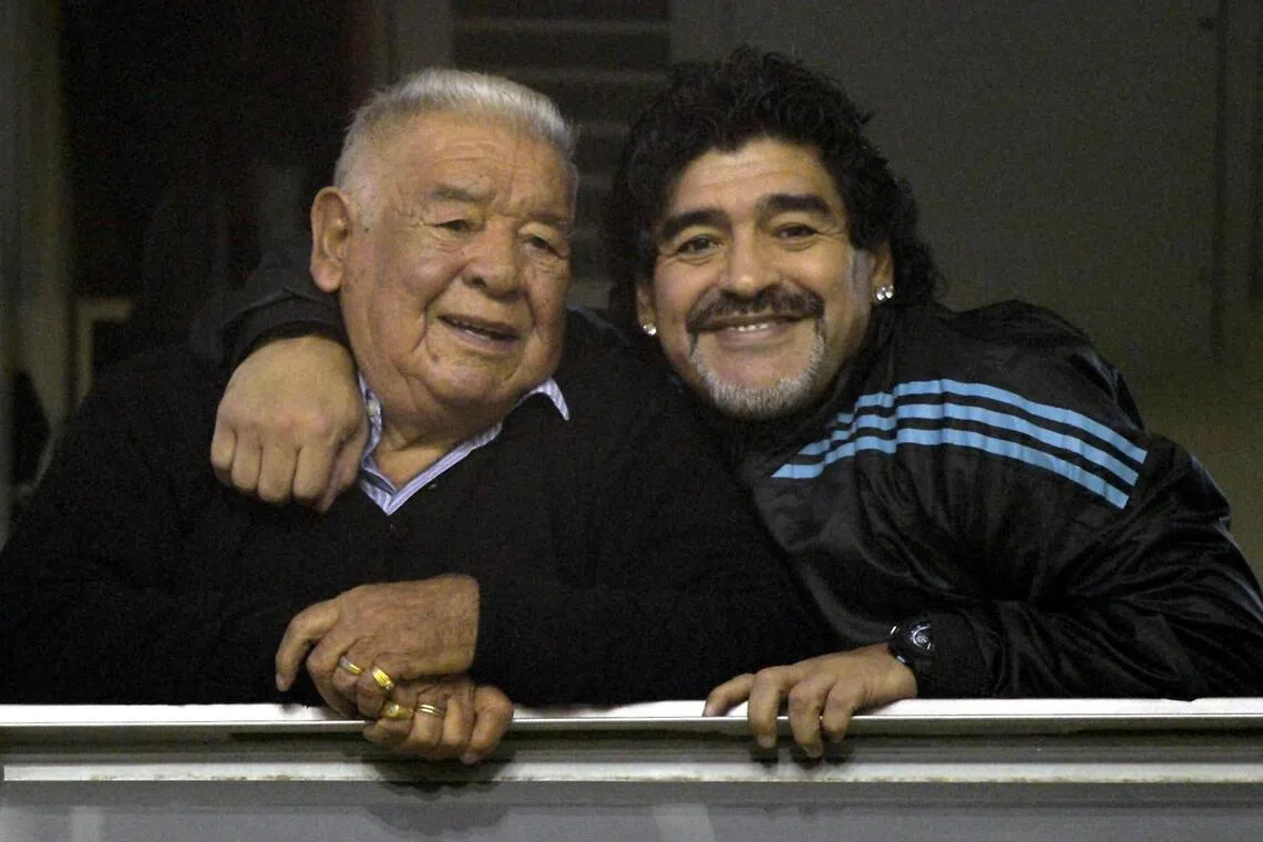 The trial over the death of football legend Diego Maradona, seen with his father, has been postponed for a week.