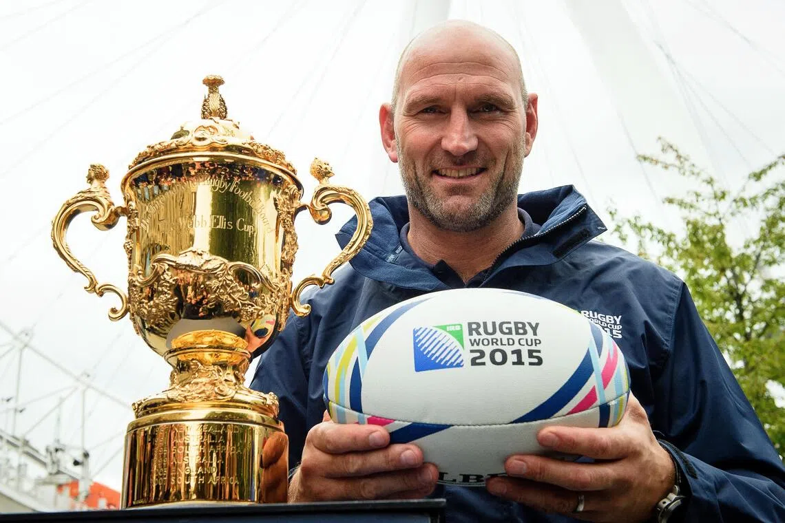 Lawrence Dallaglio poses with a rugby ball and the Webb Ellis Cup in London in ahead of the 2015 Rugby Union World Cup.