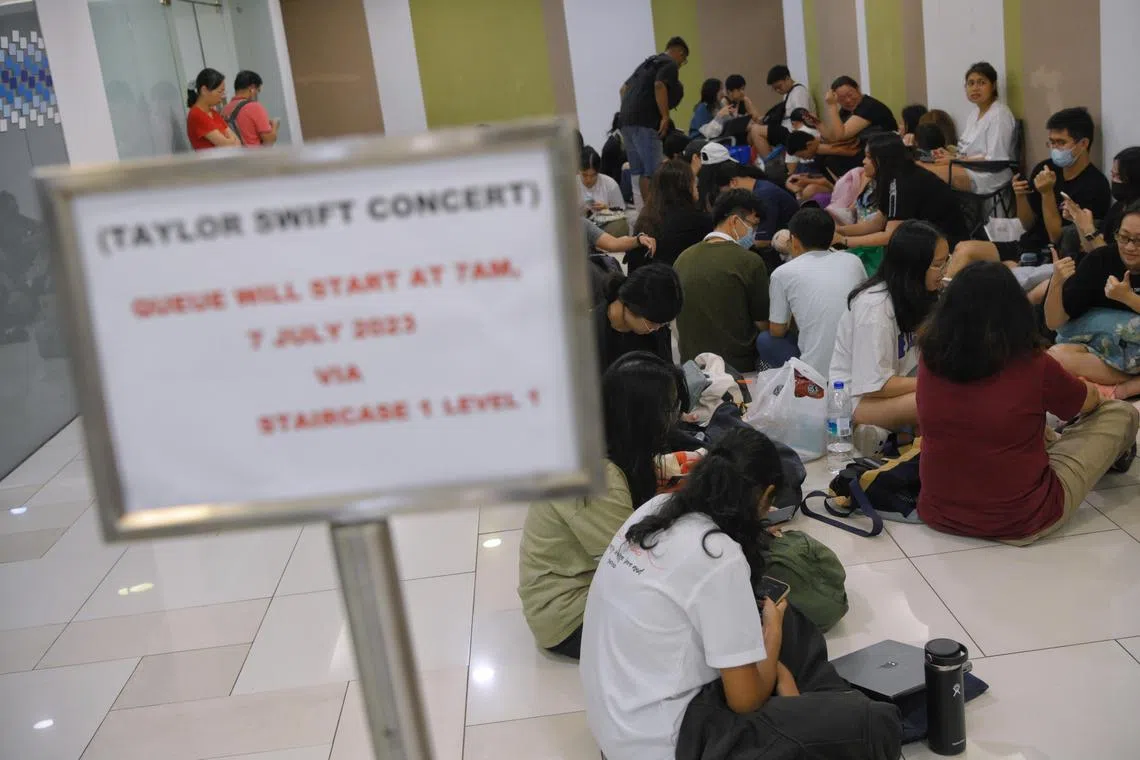 A crowd waits for the SingPost outlet at Woodlands Civic Centre to open on July 7, 2023.