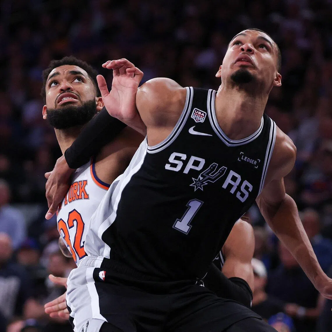 Victor Wembanyama of the San Antonio Spurs (right) and Karl-Anthony Towns battle for position during the Spurs' 115-111 win over the New York Knicks in Game 3 of the NBA Finals at Madison Square Garden on June 8, 2026 in New York City.