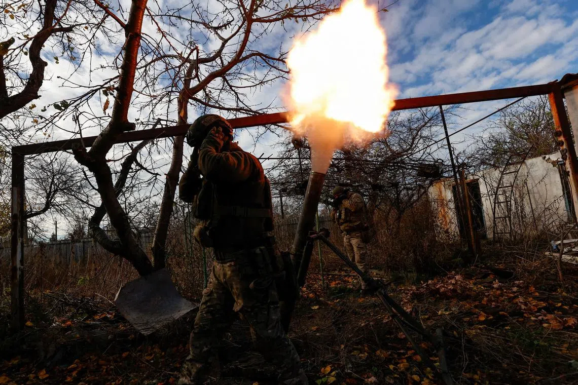 Ukrainian servicemen fire a mortar towards Russian troops, in the front line town of Avdiivka, in Ukraine's Donetsk region.     