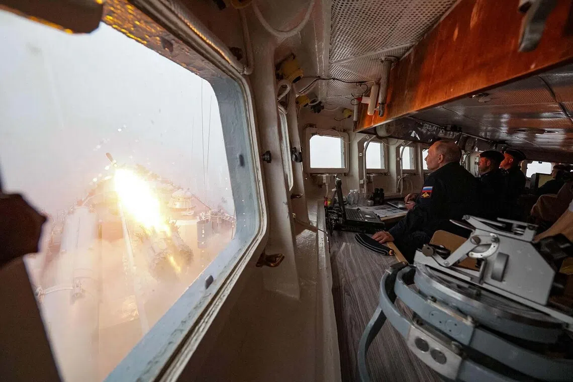 TOPSHOT - In this pool photograph distributed by the Russian state agency Sputnik, Russia's President Vladimir Putin oversees the final stage of a Pacific Fleet's naval drills from onboard the Russian Navy's guided missile cruiser Varyag off far eastern Sakhalin Island on August 12, 2026. (Photo by Gavriil Grigorov / POOL / AFP)