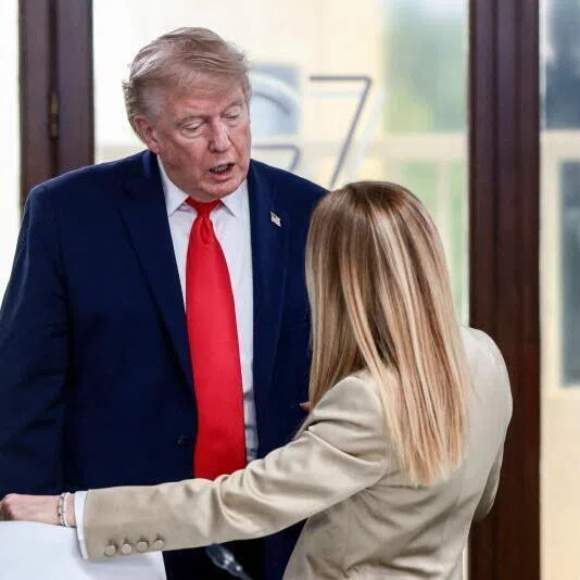 US President Donald Trump speaking with Italy's Prime Minister Giorgia Meloni during a work lunch on June 16 at the G-7 summit, in Evian, France.