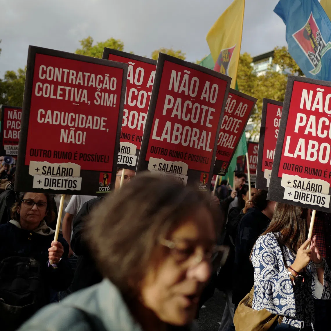 People hold placards during a demonstration held by the General Confederation of the Portuguese Workers (CGTP) demanding better wages and working conditions, in Lisbon, Portugal, November 8, 2025. REUTERS/Pedro Nunes