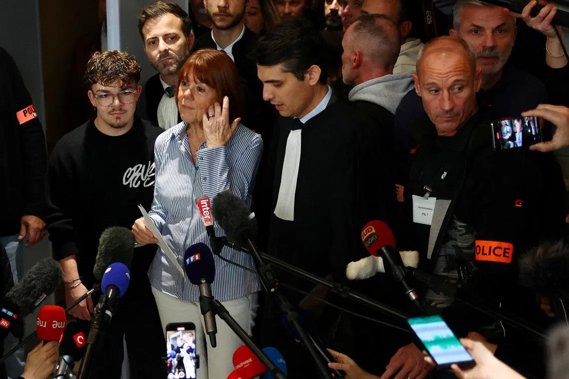 Frenchwoman Gisele Pelicot, the victim of a mass rape orchestrated by her then-husband Dominique Pelicot at their home in the southern French town of Mazan, talks to journalists, surrounded by relatives and her lawyers, after the verdict in the trial for Dominique Pelicot and 50 co-accused, at the courthouse in Avignon, France, December 19, 2024. REUTERS/Manon Cruz