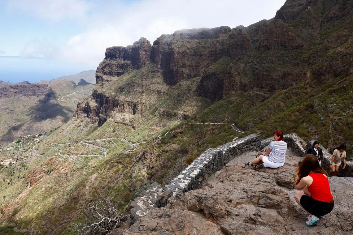 Tourists visit a viewing point overlooking the Masca ravine, where British teenager Jay Slater went missing.