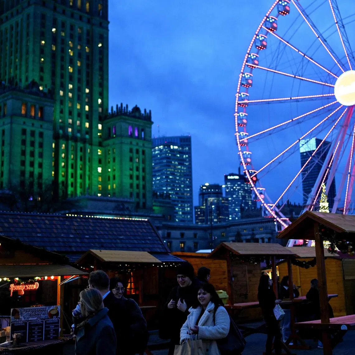 People visit the Christmas market in front of the Palace of Culture and Science in Warsaw.