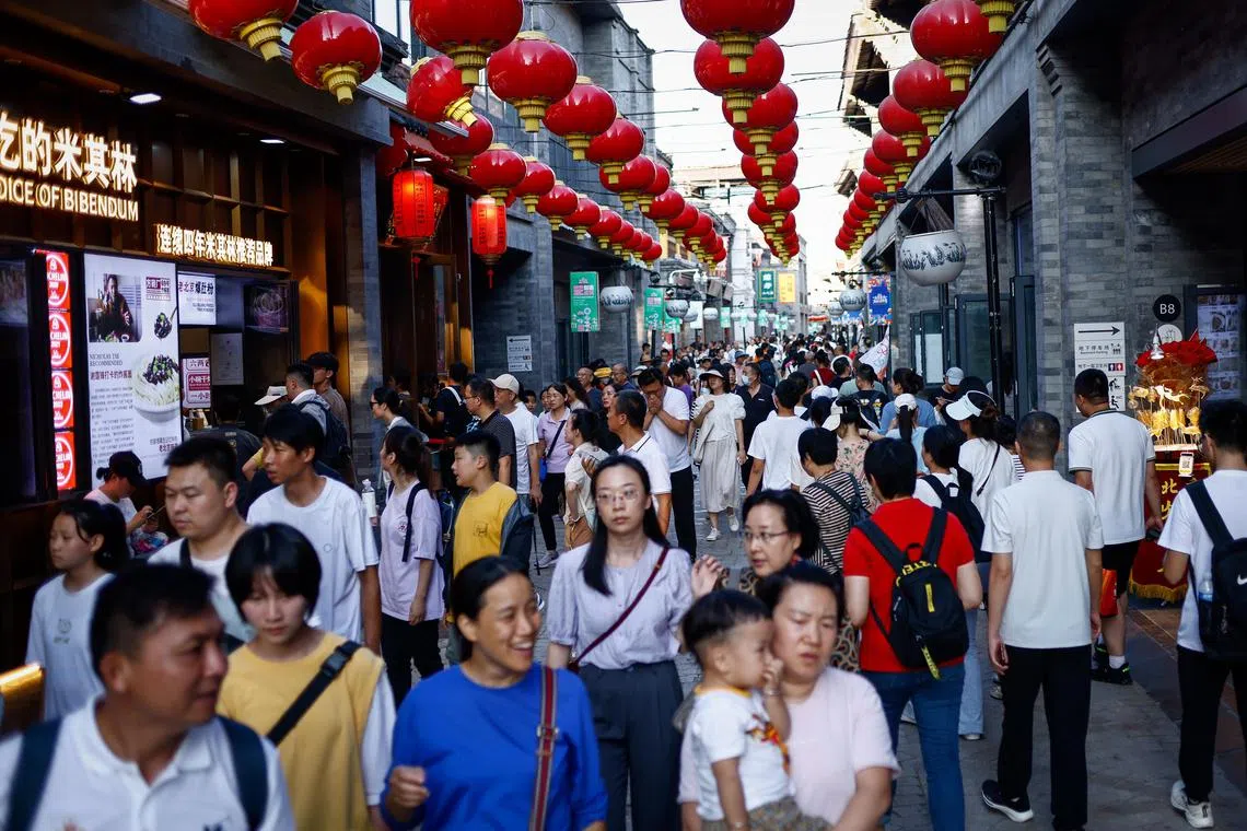 epa10767809 People walk around a shopping district in Beijing, China, 25 July 2023. China's leaders pledged to step up measures to support the economy such as adapting to demand and supply dynamics in the property market, expanding domestic demand and optimizing the business environment for private enterprises as a Politburo meeting later in the week will be held to review China's economic performance in the first half of the year.  EPA-EFE/MARK R. CRISTINO