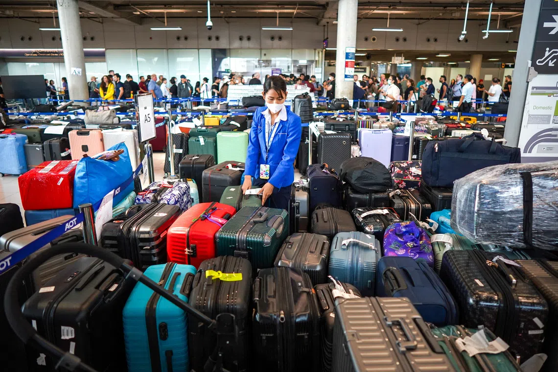 An airport officer arranges baggage from Thai Airways flights at Suvarnabhumi International Airport, after heavy rain and flooding disrupted the airline's ground operations, in Bangkok, Thailand, September 29, 2026. REUTERS/Athit Perawongmetha TPX IMAGES OF THE DAY